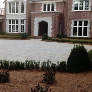 brick driveway and shrubs