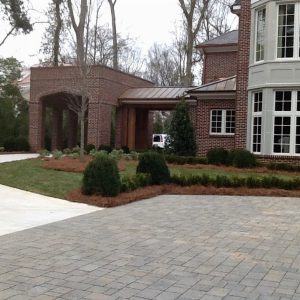 brick driveway and shrubs