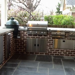 outdoor grill with red brick wall