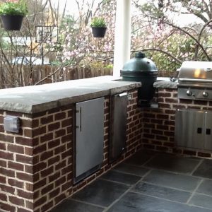 outdoor grill with red brick wall