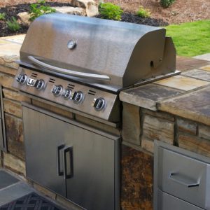 outdoor grill with stone wall