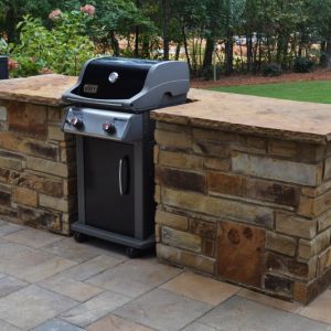 outdoor grill with stone wall