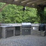 outdoor grill with stone wall