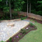 firepit and stone wall in backyard