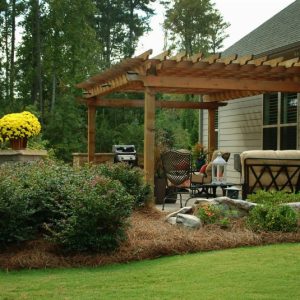 pergola with shrubs and pinestraw