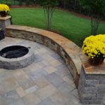 firepit with stone wall and flowers